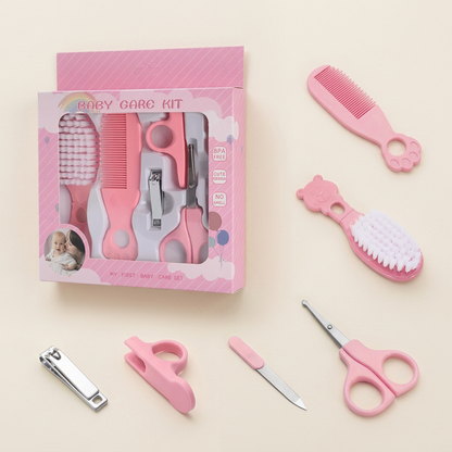 Pink baby grooming kit on a warm ivory background