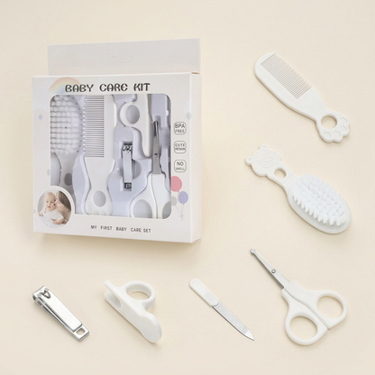 White baby grooming kit on a warm ivory background
