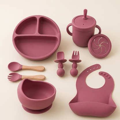 Pink Set silicone baby feeding set with bowl, plate, bib, cup and utensils on ivory