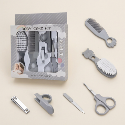 Grey baby grooming kit on a warm ivory background