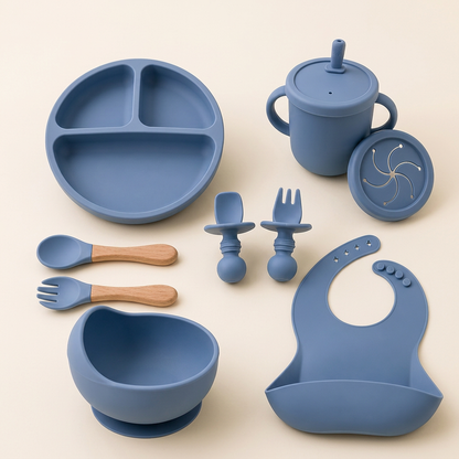 Blue Set silicone baby feeding set with bowl, plate, bib, cup and utensils on ivory