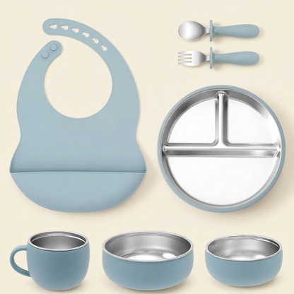 Ether seven-piece stainless steel and silicone mealtime set on an ivory background