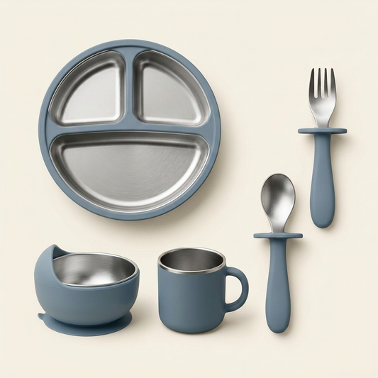 Single blue-grey stainless steel feeding set with divided plate, silicone-covered bowl, handled cup, fork and spoon on warm ivory