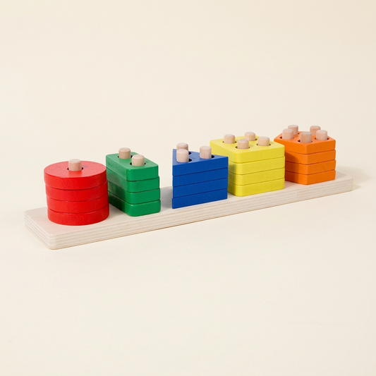 Single assembled wooden stacking and sorting board with five coloured shape stacks on warm ivory